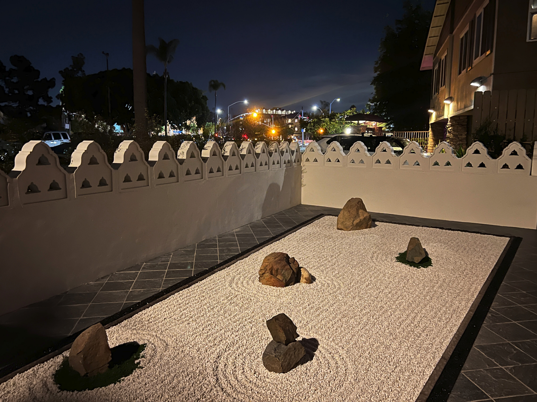 Installed zen rock garden at night with raked white gravel