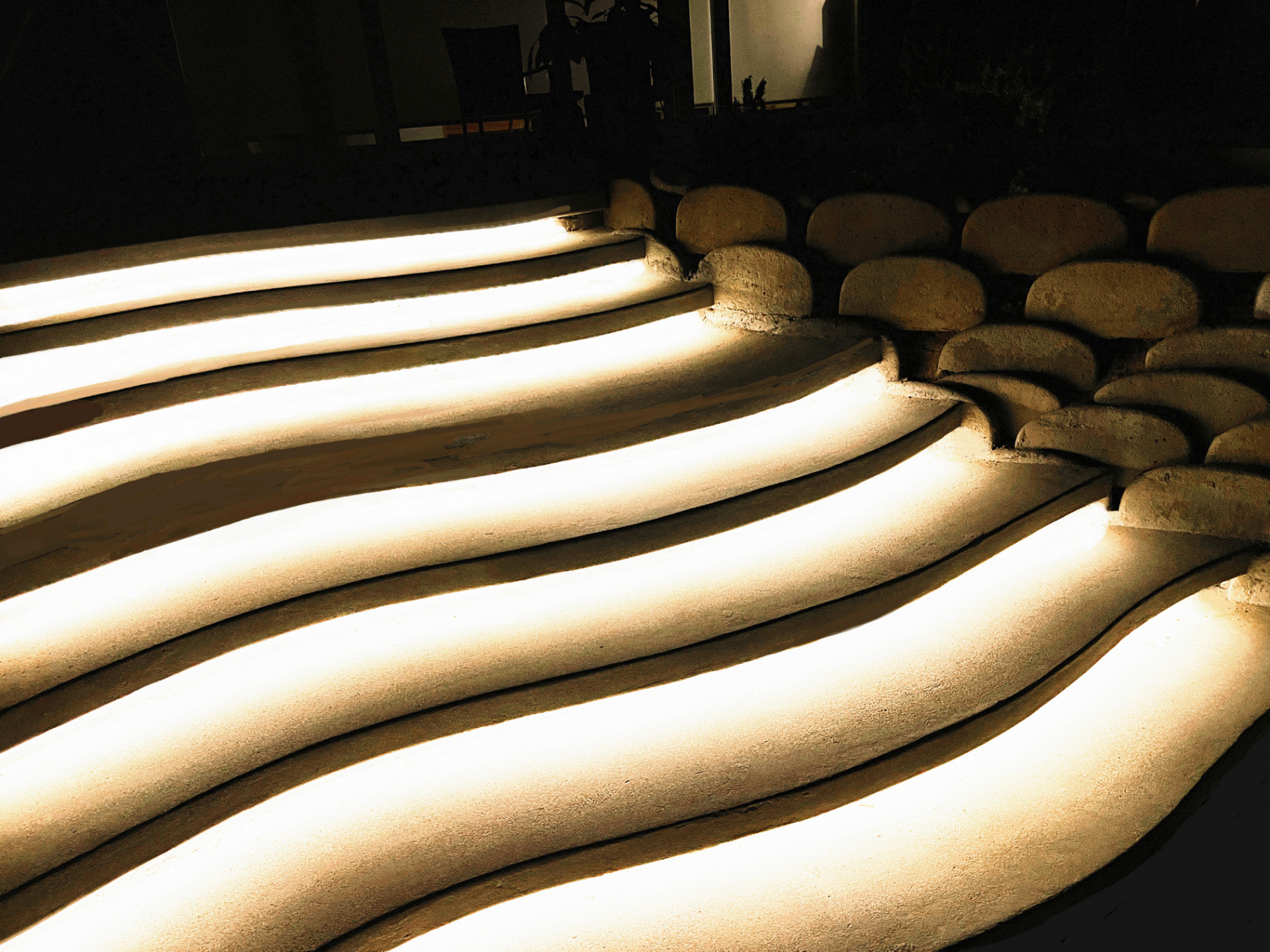 Curvilinear lit concrete steps at night
