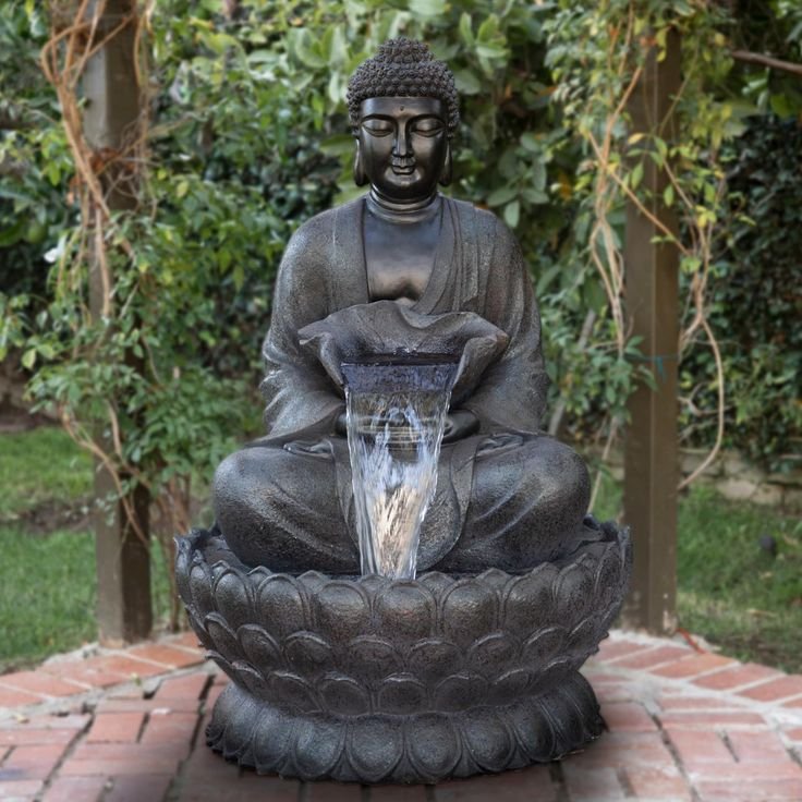 Stone Buddha fountain in a peaceful garden setting